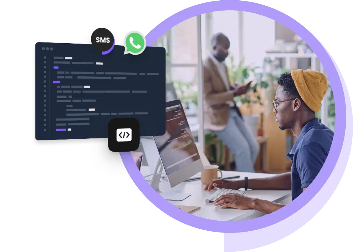 Developer in the office working on messaging API integration for WhatsApp and SMS