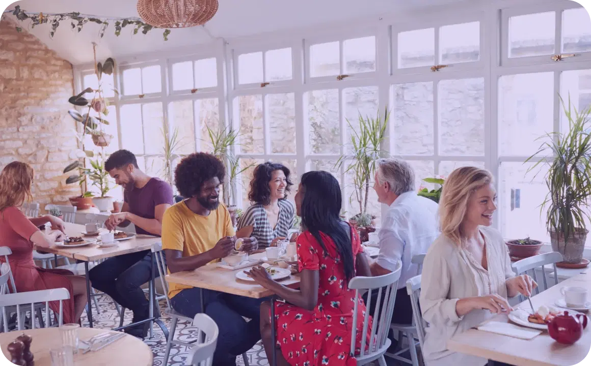 People having lunch in a restaurant that uses TopMessage for communication platform