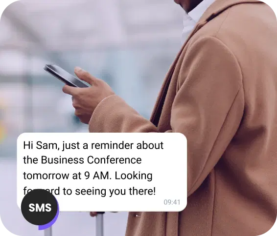 Man on the street reading an SMS appointment reminder