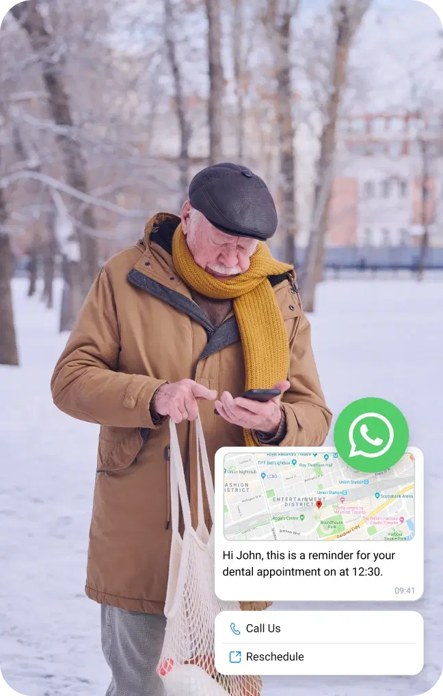 Elderly man in the snow checking his mobile for location via WhatsApp business message