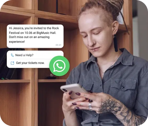 Girl with a tattoo checking her phone for a rock festival invitation received via WhatsApp