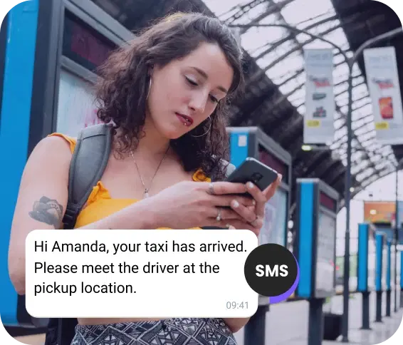 Girl with a backpack at the station checking an SMS about her arriving taxi