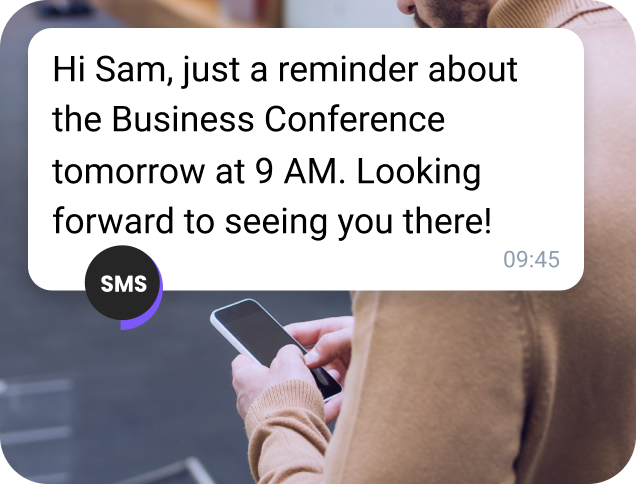 AI-generated conference reminder message sent via TopMessage SMS on a smartphone screen.