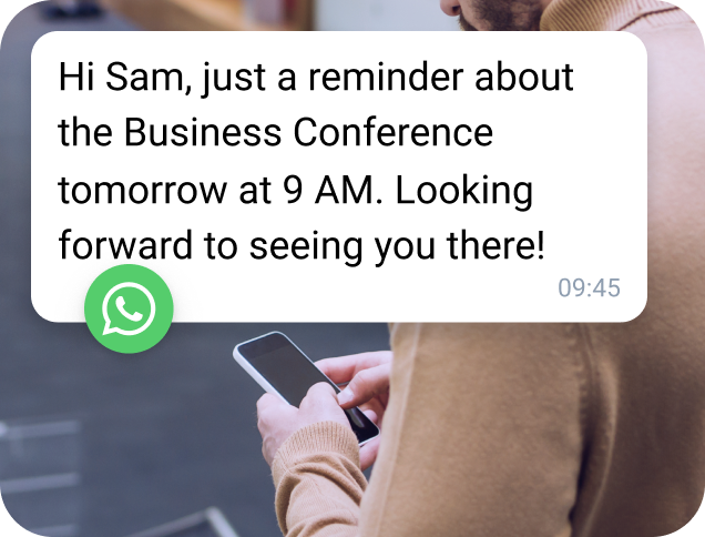 AI-generated conference reminder message sent via TopMessage on WhatsApp, displayed on a smartphone screen.