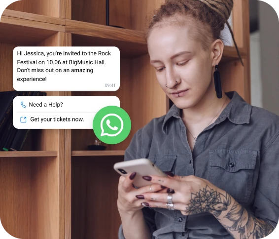 Girl with a tattoo checking her phone for a rock festival invitation received via WhatsApp